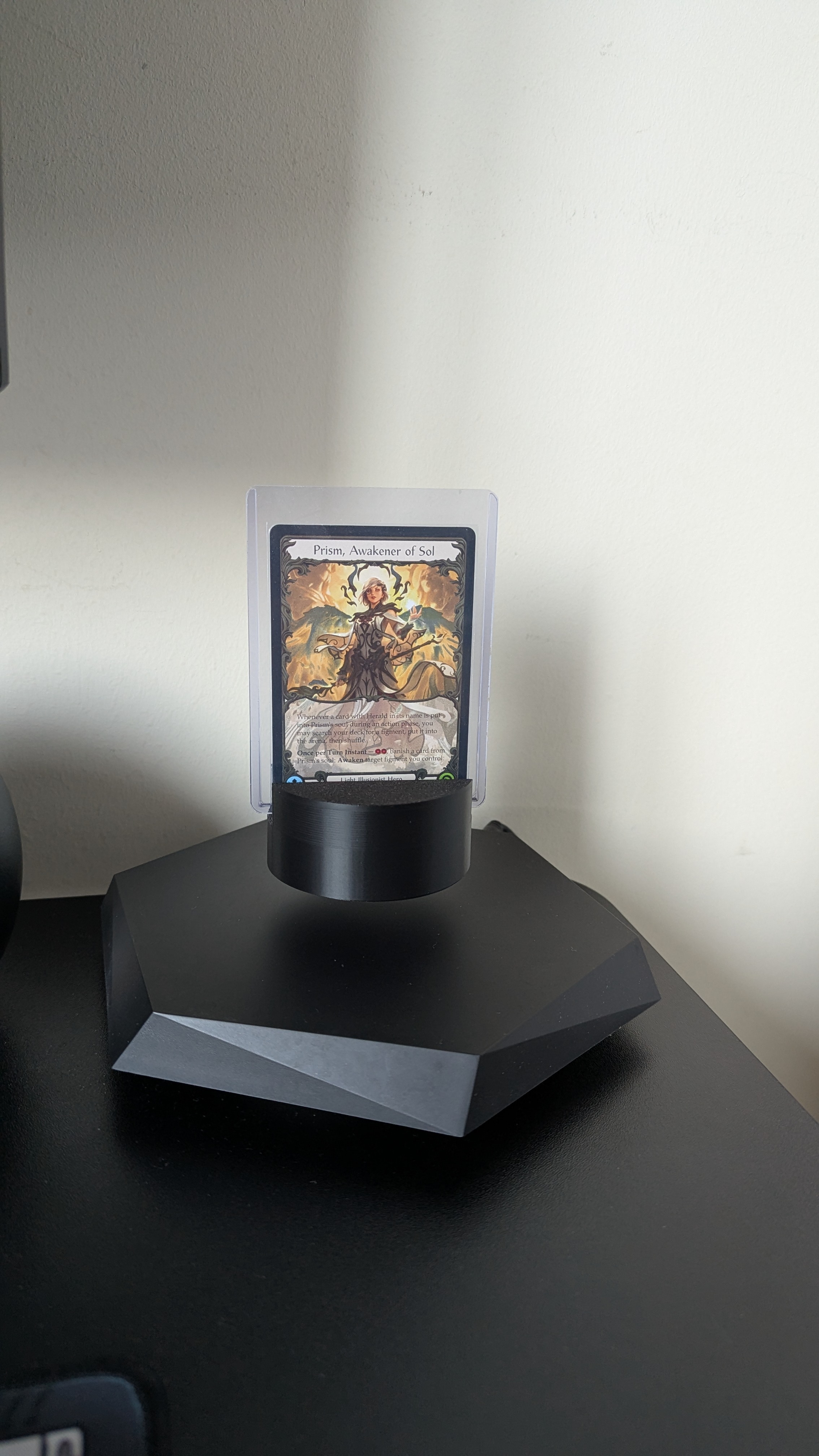 Card in a top loader on the Polaris TCG stand